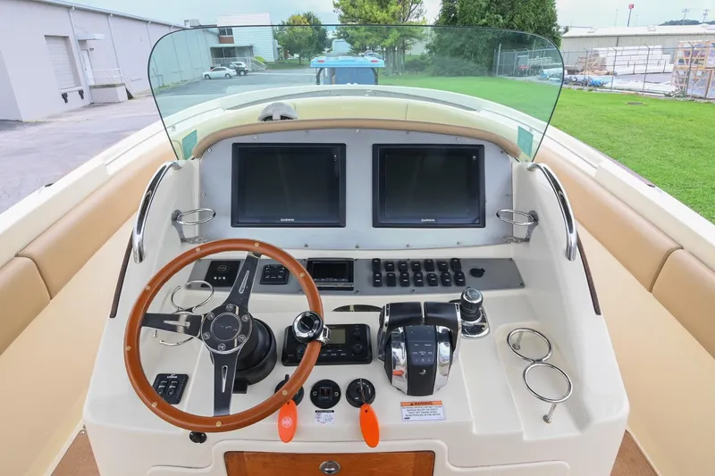 Slide: The Image of 2016 Chris-Craft Catalina 29 helm with dual screens and wooden steering wheel. - 30