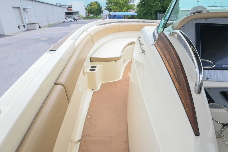 Slide: The Image of 2016 Chris-Craft Catalina 29 boat interior with beige seating and wood accents. - 34