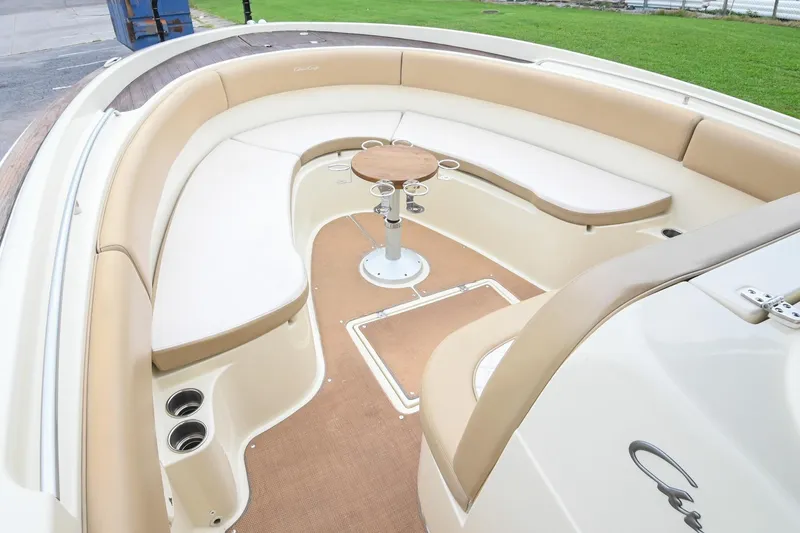 Slide: The Image of 2016 Chris-Craft Catalina 29 boat interior with beige seating and round table. - 35