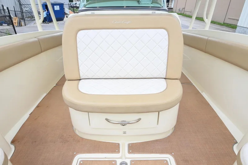 Slide: The Image of 2016 Chris-Craft Catalina 29 boat interior with beige and white cushioned seating. - 37