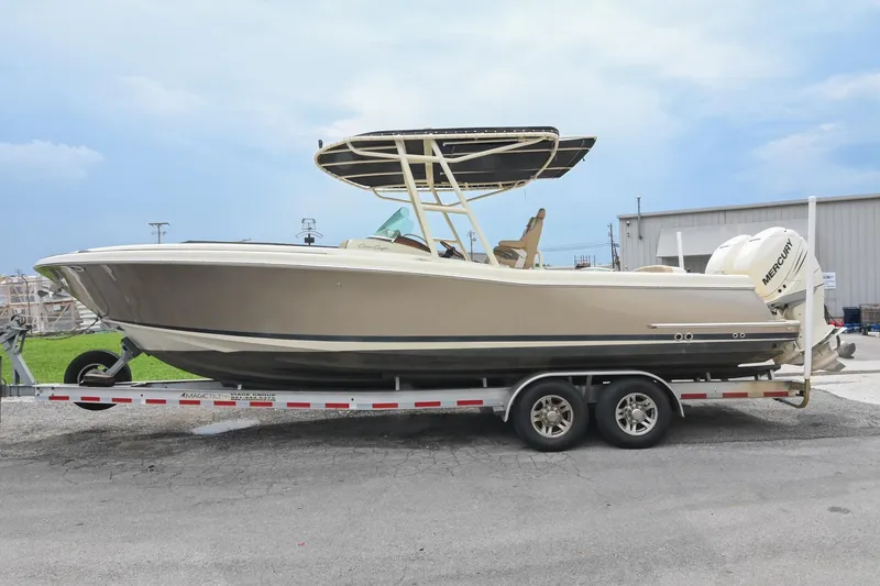 Slide: The Image of 2016 Chris-Craft Catalina 29 cruising on a scenic lake with lush greenery. - 4