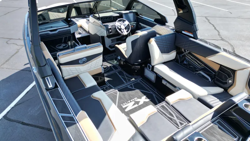 Slide: The Image of 2025 Tigé Ultré 23ZX boat interior with luxurious seating and modern dashboard. - 11