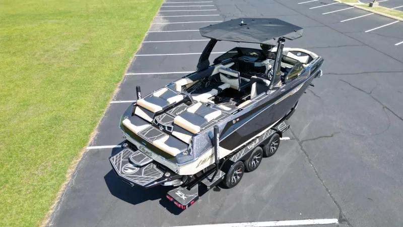 Slide: The Image of 2025 Tigé Ultré 23ZX boat on trailer in parking lot, aerial view. - 13
