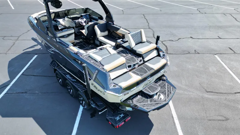 Slide: The Image of 2025 Tigé Ultré 23ZX boat in parking lot, showcasing sleek design and luxurious seating. - 15