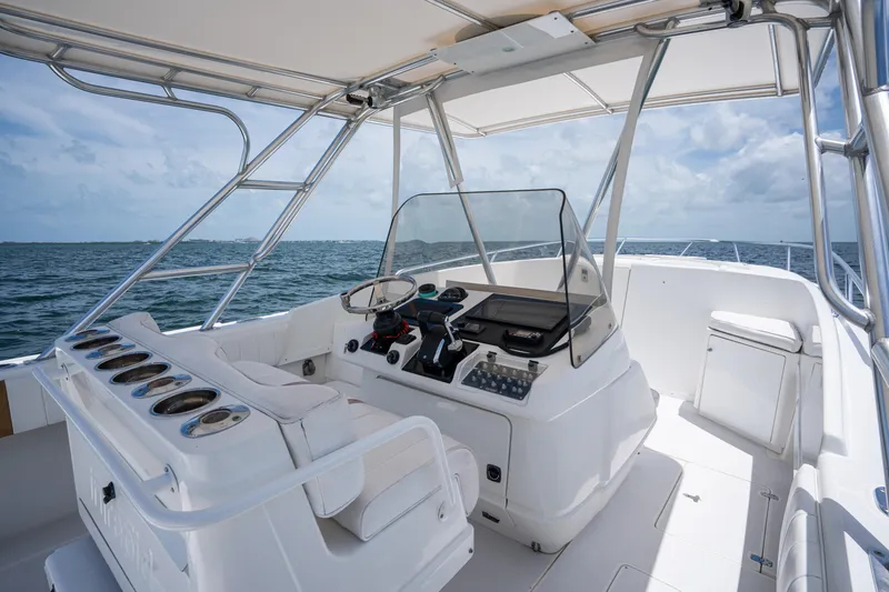 Slide: The Image of 1999 Intrepid 35 boat interior with helm, ocean view, and clear sky. - 14