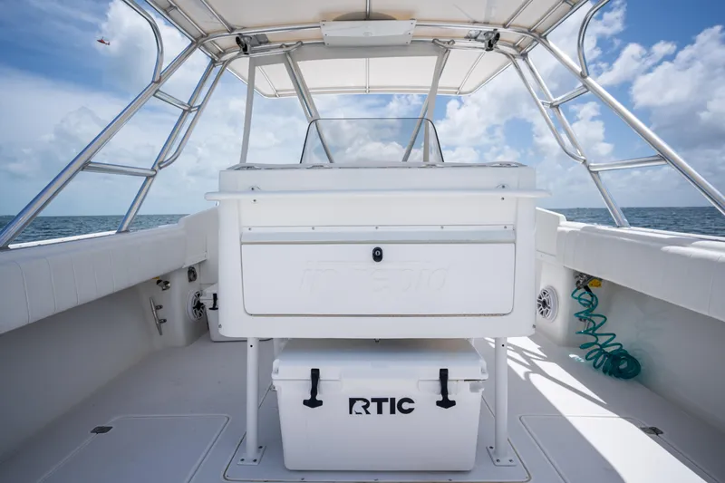 Slide: The Image of 1999 Intrepid 35 boat interior with RTIC cooler, ocean view, and clear sky. - 15