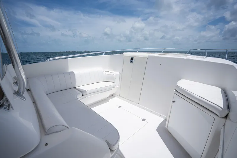Slide: The Image of 1999 Intrepid 35 boat interior with white seating, ocean view, and blue sky. - 17