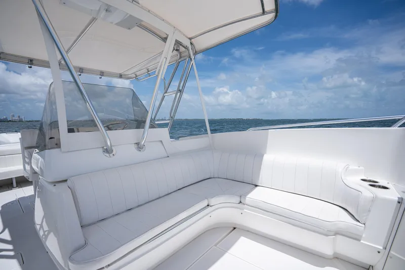 Slide: The Image of 1999 Intrepid 35 boat interior with white seating, ocean view, and blue sky. - 18