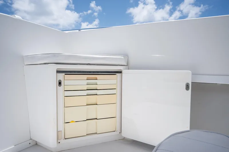Slide: The Image of 1999 Intrepid 35 boat storage compartment with open door under blue sky. - 19