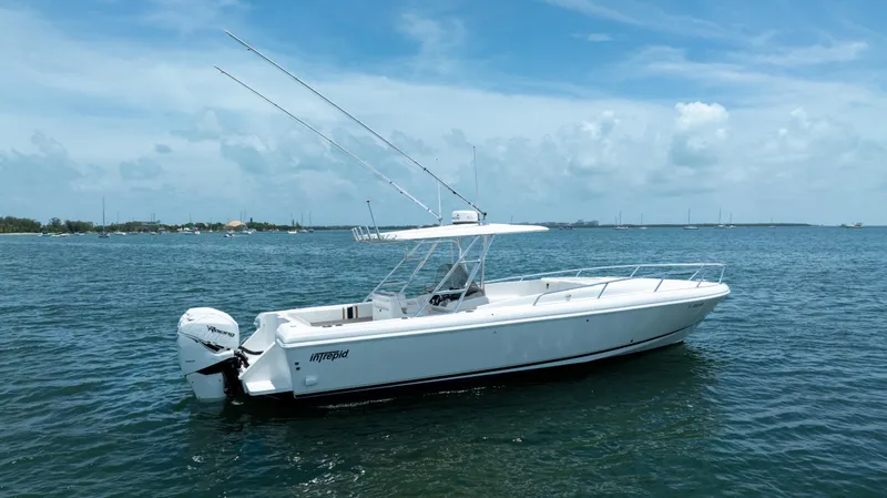 Slide: The Image of 1999 Intrepid 35 boat on calm ocean waters under a clear blue sky. - 2