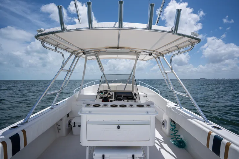 Slide: The Image of 1999 Intrepid 35 boat interior with helm, ocean view, and clear sky. - 21