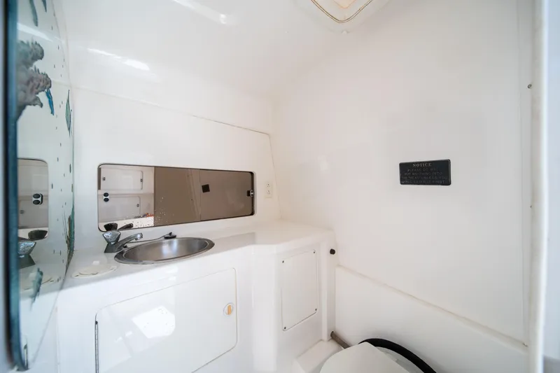 Slide: The Image of Interior of 1999 Intrepid 35 boat bathroom with sink and mirror. - 27