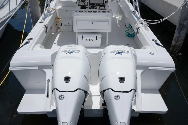 Slide: The Image of 1999 Intrepid 35 boat with dual 400R outboard engines, docked in a marina. - 28