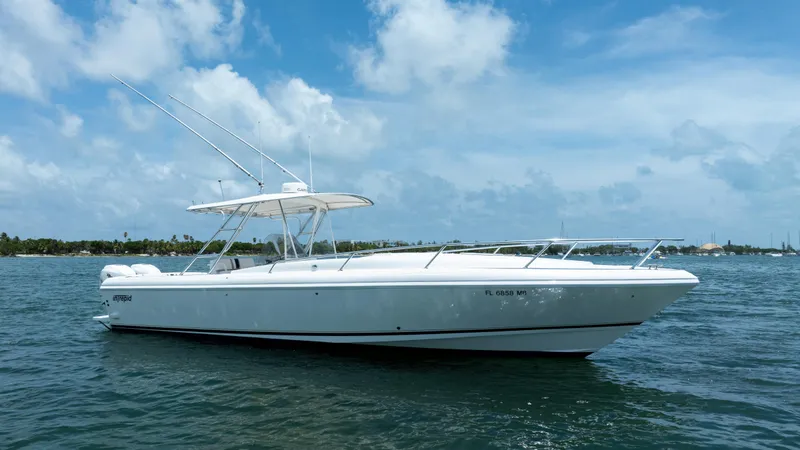 Slide: The Image of 1999 Intrepid 35 boat on water under blue sky. - 3