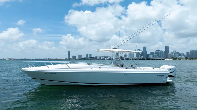 Slide: The Image of 1999 Intrepid 35 boat on water with city skyline in background, under blue sky. - 4