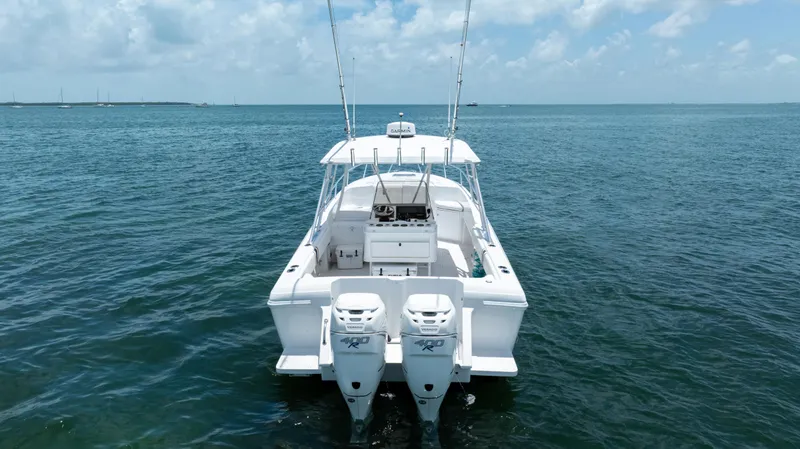 Slide: The Image of 1999 Intrepid 35 boat on open water, featuring dual outboard engines. - 7