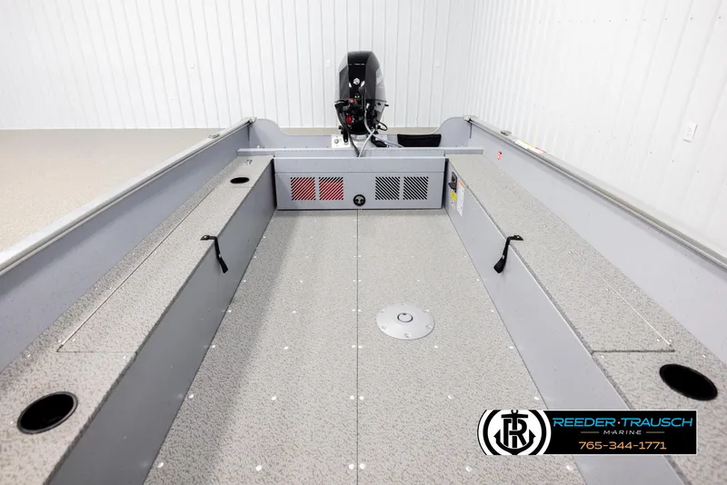 Slide: The Image of 2026 Lund 1600 Fury Tiller boat interior with motor, displayed in a showroom. - 12