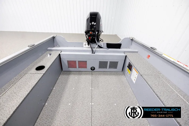 Slide: The Image of 2026 Lund 1600 Fury Tiller boat interior with motor, gray finish, Reeder-Trausch Marine logo. - 13