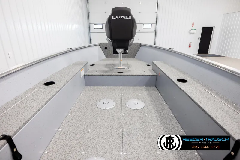 Slide: The Image of 2026 Lund 1600 Fury Tiller boat interior, spacious layout, gray finish, Reeder-Trausch Marine logo. - 15