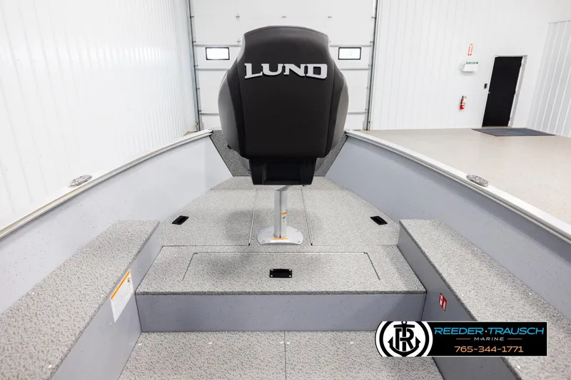 Slide: The Image of 2026 Lund 1600 Fury Tiller boat interior with seating and storage compartments. - 16