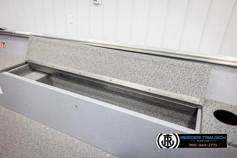 Slide: The Image of 2026 Lund 1600 Fury Tiller boat interior with storage compartment and textured finish. - 18