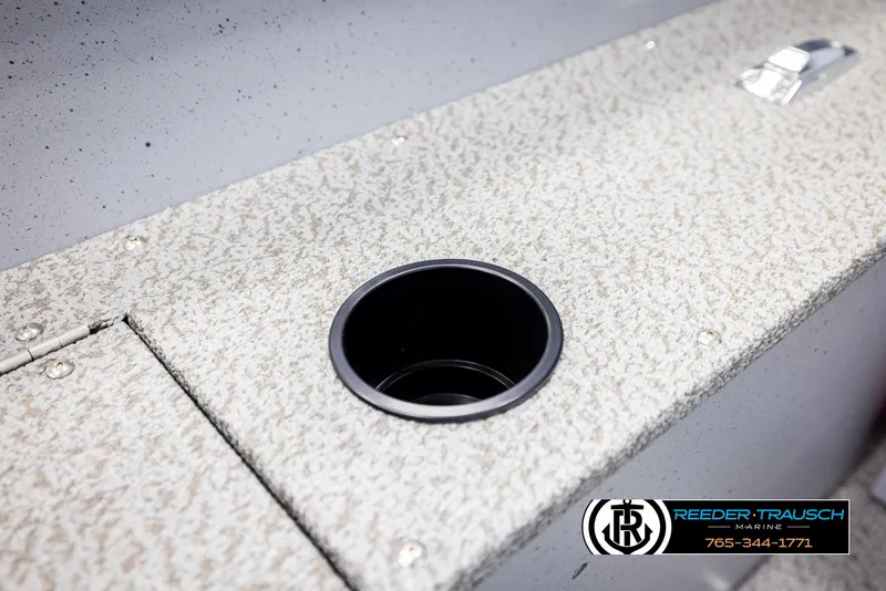 Slide: The Image of 2026 Lund 1600 Fury Tiller boat interior with cup holder and textured surface. - 19