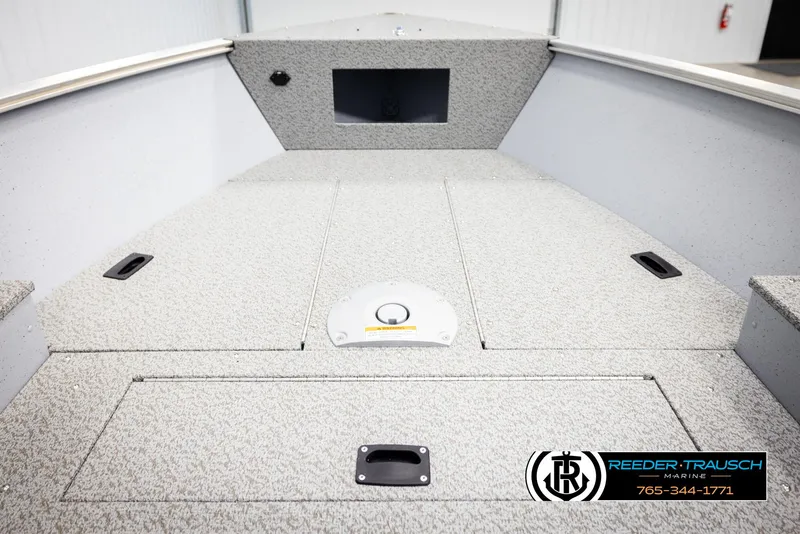 Slide: The Image of 2026 Lund 1600 Fury Tiller boat interior with storage compartments, Reeder-Trausch Marine logo. - 20