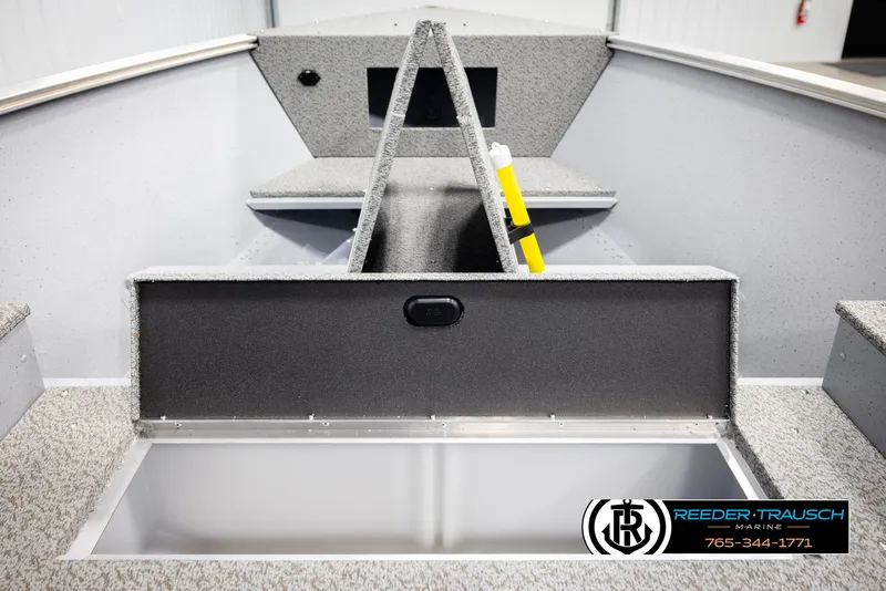 Slide: The Image of 2026 Lund 1600 Fury Tiller boat interior with storage compartment and Reeder-Trausch Marine logo. - 21