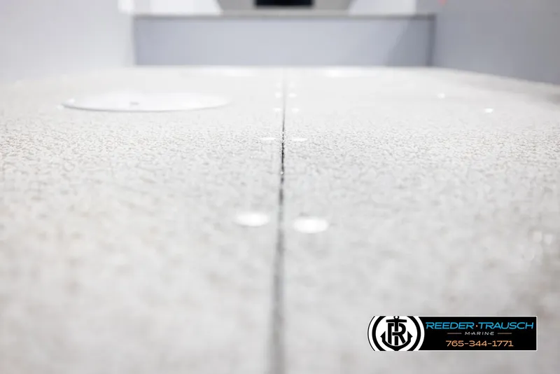 Slide: The Image of 2026 Lund 1600 Fury Tiller boat deck, textured surface, Reeder-Trausch Marine logo. - 23