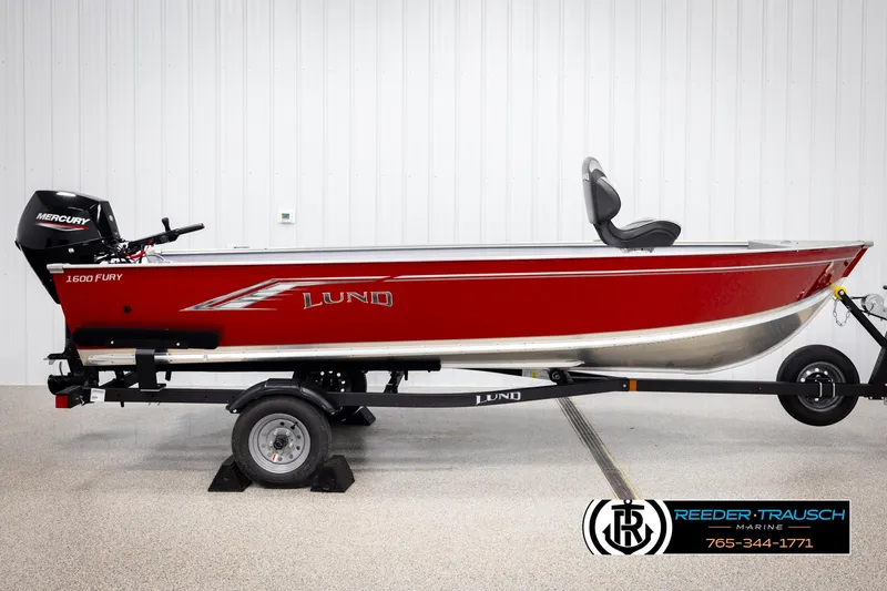 Slide: The Image of 2026 Lund 1600 Fury Tiller boat in red, on a trailer, with Mercury engine. - 3