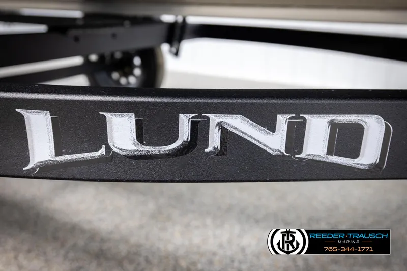 Slide: The Image of 2026 Lund 1600 Fury Tiller boat trailer with logo and Reeder-Trausch Marine contact. - 33