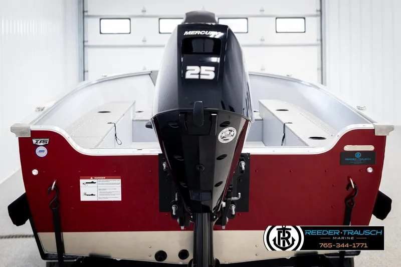 Slide: The Image of 2026 Lund 1600 Fury Tiller boat with Mercury 25 outboard motor in a garage setting. - 5