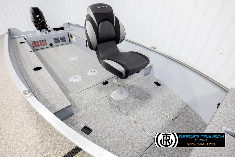 Slide: The Image of 2026 Lund 1600 Fury Tiller boat interior with swivel seat and motor, Reeder-Trausch Marine logo. - 7
