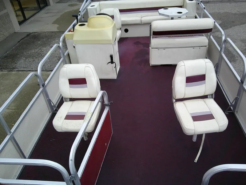 Slide: The Image of Interior of a 1997 Misty Harbor 2020 EF pontoon boat with white seating and maroon carpet. - 9