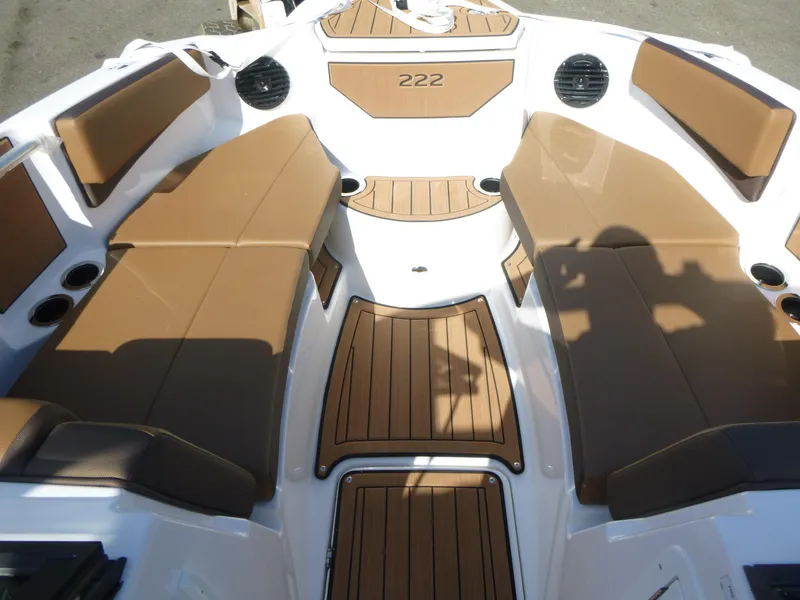 Slide: The Image of 2025 Yamaha Boats 222SD interior with brown seating and wood accents. - 10