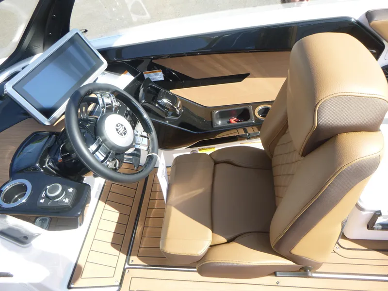 Slide: The Image of 2025 Yamaha Boats 222SD cockpit with steering wheel, touchscreen, and tan seating. - 7
