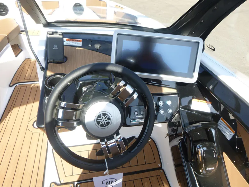 Slide: The Image of 2025 Yamaha Boats 222SD dashboard with steering wheel and touchscreen display. - 8