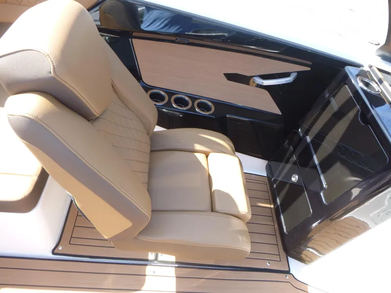 Slide: The Image of Luxurious interior of 2025 Yamaha Boats 222SD with tan seating and sleek design. - 9