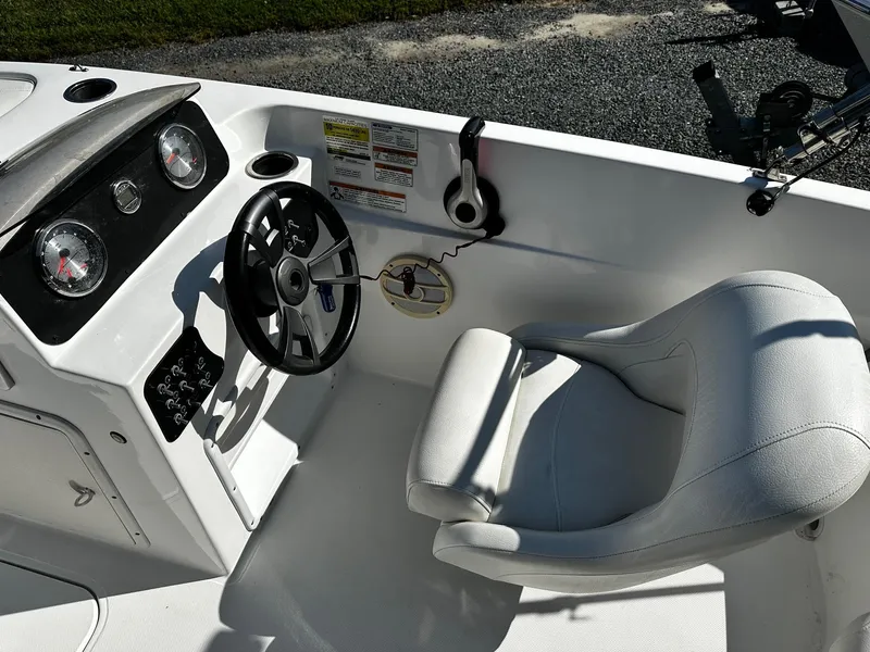 Slide: The Image of 2014 Godfrey Hurricane 188SDS Sport boat cockpit with steering wheel and gauges. - 8