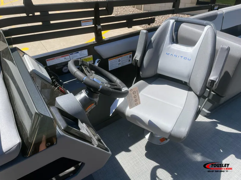 Slide: The Image of 2025 Manitou Cruise 20 MAX Bench Twin Tube boat interior with steering wheel and seat. - 5