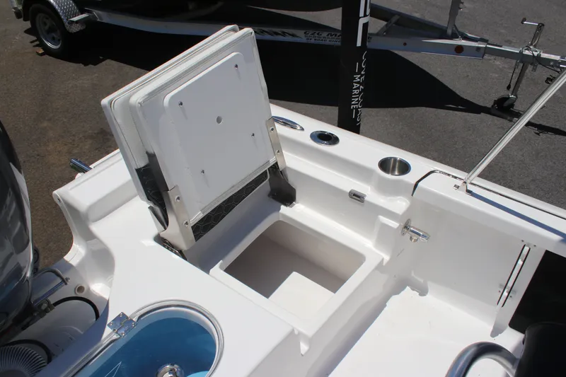 Slide: The Image of 2026 Tidewater 1910 Bay Max boat interior with storage compartment and cup holders. - 19
