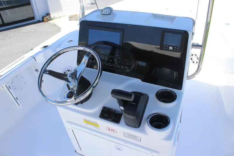 Slide: The Image of 2026 Tidewater 1910 Bay Max boat console with steering wheel and navigation controls. - 22