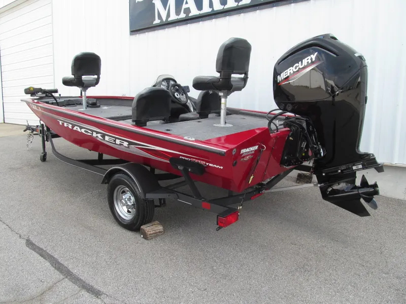 Slide: The Image of 2023 Tracker Pro Team 175 TF boat with Mercury engine, red exterior, parked on trailer. - 3
