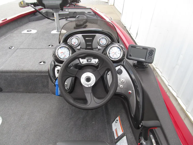 Slide: The Image of 2023 Tracker Pro Team 175 TF boat dashboard with steering wheel and gauges. - 6