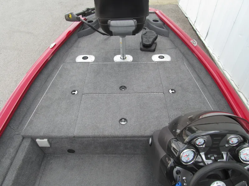 Slide: The Image of 2023 Tracker Pro Team 175 TF boat interior with gray carpet and red trim. - 7