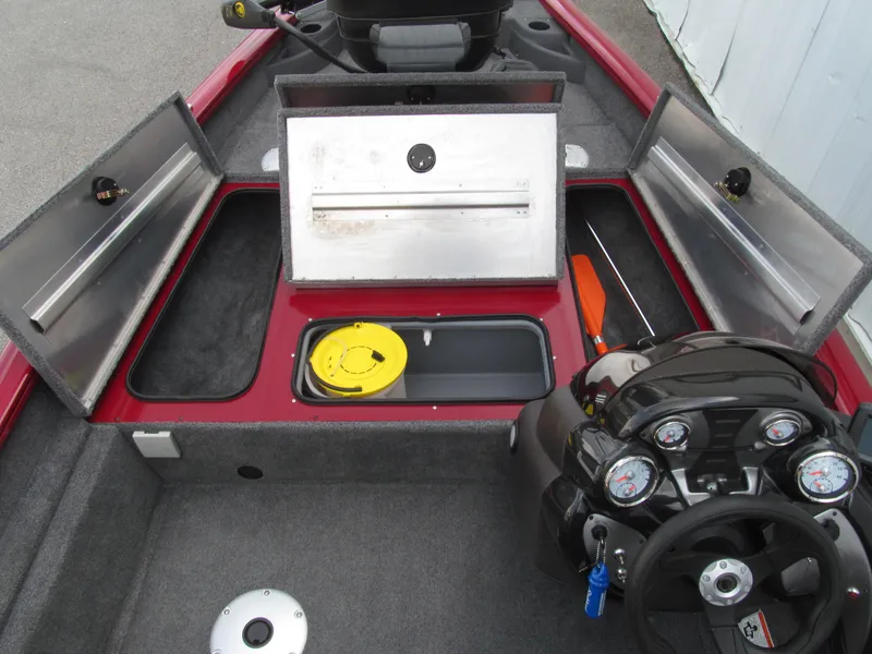 Slide: The Image of 2023 Tracker Pro Team 175 TF boat interior with storage compartments and control panel. - 8