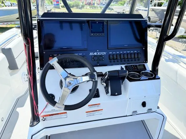 Slide: The Image of 2022 Blackfin 252 CC boat seating with white and gray upholstery, showcasing modern design. - 12