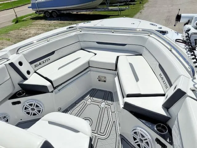 Slide: The Image of 2022 Blackfin 252 CC boat interior with cushioned seating and built-in speakers. - 21