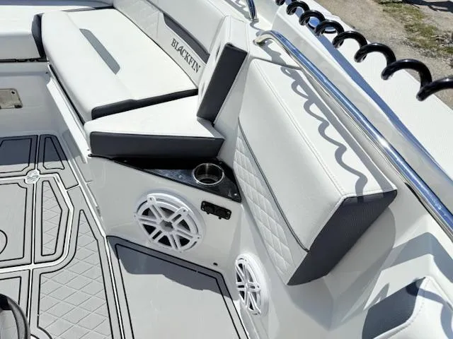 Slide: The Image of 2022 Blackfin 252 CC boat interior with white seating and speaker system. - 22