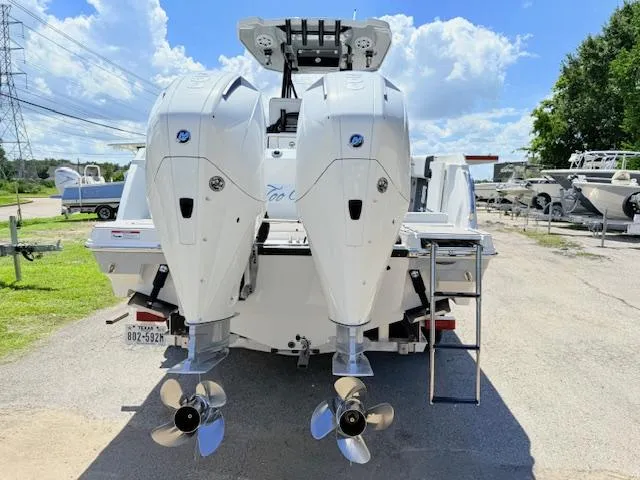 Slide: The Image of 2022 Blackfin 252 CC boat on trailer with dual Mercury engines, parked outdoors. - 3